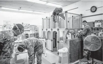  ?? ANDREW SENG/THE NEW YORK TIMES ?? Members of the National Guard use a bleach solution to help clean toys in March at a community center in Scarsdale, New York.