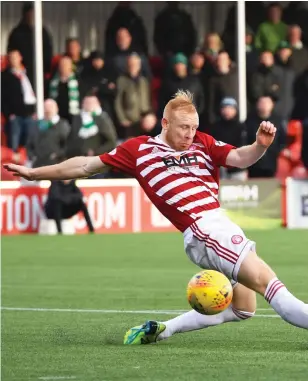  ??  ?? Celtic midfielder Ryan Christie hammers home the opener yesterday, his