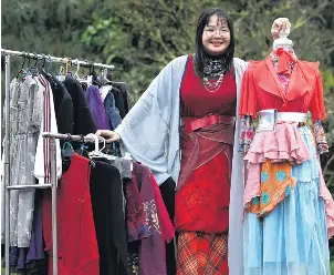  ?? PHOTO: PETER MCINTOSH ?? Sew much fun . . . Trinity Catholic College student Vania Wong, 16, showcases a rack of secondhand and upcycled clothing.