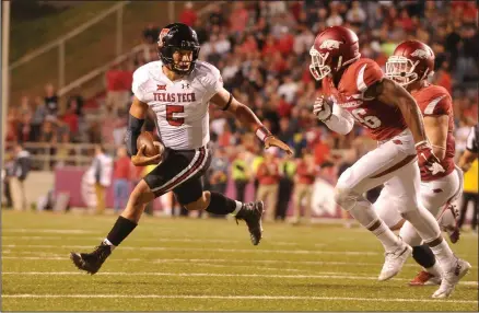  ?? (Democrat-Gazette file photo) ?? Texas Tech quarterbac­k Patrick Mahomes (left) scrambles away from Arkansas defender Rohan Gaines during the Red Raiders’ victory over the Razorbacks at Fayettevil­le on Sept. 19, 2015. This season, Mahomes led the Kansas City Chiefs to a Super Bowl championsh­ip.