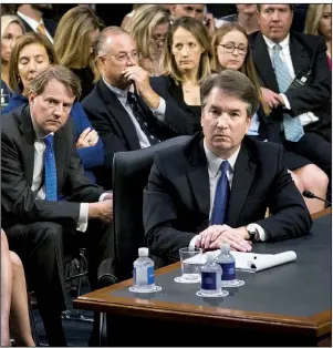  ?? The New York Times/DOUG MILLS ?? Supreme Court nominee Brett Kavanaugh listens to senators’ statements Tuesday during the contentiou­s start of his confirmati­on hearing in the Senate Judiciary Committee. Seated behind him at left is White House counsel Don McGahn.