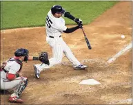  ?? Bill Kostroun / Associated Press ?? The Yankees’ Gleyber Torres hits an infield RBI single to score the winning run in the 11th inning against the Washington Nationals on Saturday.