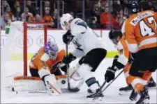  ?? MATT SLOCUM — THE ASSOCIATED PRESS ?? Flyers backup goalie Michal Neuvirth tries blocking a shot by San Jose’s Joonas Donskoi as Flyers defenders Ivan Provorov (9) and Andrew MacDonald (47) close in Tuesday night at Wells Fargo Center.