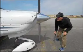  ??  ?? Brandywine Flight School owner Stephen Richards does a safety check before flying.