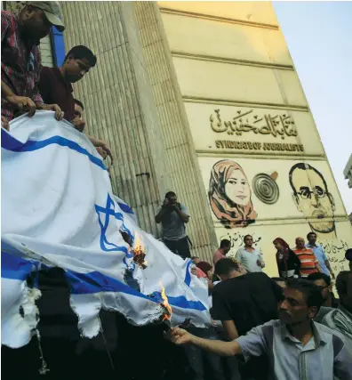  ?? (Amr Abdallah Dalsh/Reuters) ?? ACTIVISTS SHOUT slogans against Israel while burning the Israel flag during a protest in Cairo in 2015. We no longer live in the ancient reality of Christian religious antisemiti­sm, whose prime attacks came from a limited number of main perpetrato­rs.