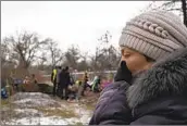  ?? Evgeniy Maloletka Associated Press ?? TAMILA PYHYDA cries last week as the body of her husband, who was killed by Russians, is exhumed.