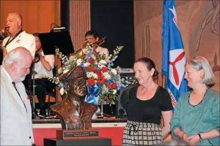  ?? MARIAN DENNIS– DIGITAL FIRST MEDIA ?? On left, sculptor Jerry McKenna helps unveil his bronze sculpture of Gen. Carl Spaatz. Katharine Gresham and Ruth Thomas, Spaatz’s granddaugh­ters, right, admire the work as it is revealed publicly for the first time.