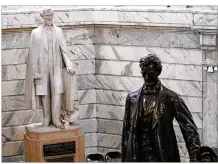  ?? BILL PUGLIANO / GETTY IMAGES ?? A statue of Confederat­e President Jefferson Davis (left) stands near a statue of President Abraham Lincoln at the Kentucky State Capitol building in Frankfort, Kentucky. Kentucky Gov. Matt Bevin has been urged to remove the statue of Davis.