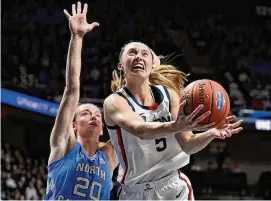  ?? Jessica Hill/Assocaited Press ?? UConn guard Paige Bueckers drives to the basket as North Carolina guard Lexi Donarski defends in the first half on Dec. 10 in Uncasville.