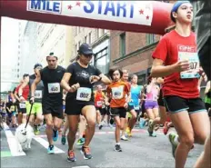  ?? Lake Fong/ Post- Gazette ?? Runners at the start on Penn Avenue in the GNC Live Well Liberty Mile in 2016 —- an event that is growing in popularity across the U. S.
