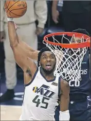  ?? Rick Bowmer Associated Press ?? DONOVAN MITCHELL attacks the basket in front of the Mavericks’ Spencer Dinwiddie at Vivint Arena.