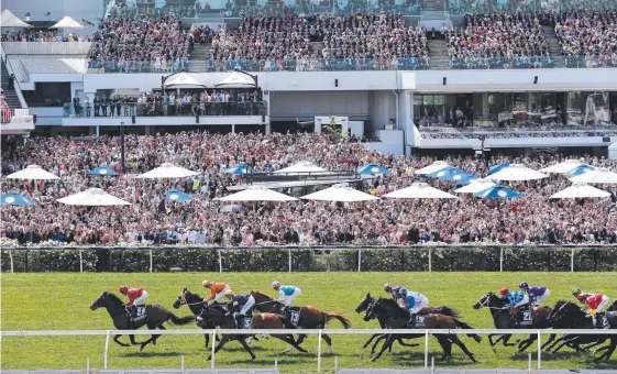  ?? Picture: GETTY IMAGES ?? A massive Flemington crowd watches last year’s Melbourne Cup.