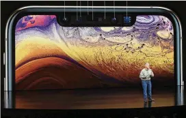  ?? PHOTOS BY MARCIO JOSE SANCHEZ / ASSOCIATED PRESS ?? Above: Phil Schiller, Apple’s senior vice president of worldwide marketing, speaks about the Apple iPhone XS during Wednesday’s event to announce new Apple products in Cupertino, Calif.Left: Apple COO Jeff Williams introduces the Apple Watch Series 4 on Wednesday.