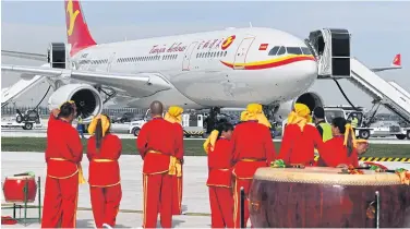  ?? AFP ?? Drummers look at the first Airbus A330 plane to be delivered before the inaugurati­on ceremony of the Airbus A330 Completion and Delivery Centre in Tianjin, China yesterday.