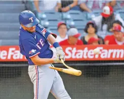  ?? MARK J. TERRILL/ASSOCIATED PRESS ?? The Rangers’ Nick Solak breaks his bat as he hits a single Friday against the Angels in Anaheim, Calif. The Rangers won 7-2.