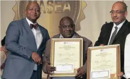  ??  ?? Michael Laing and Ram Reddy receiving their awards at the MEC’s Annual Excellence Awards recently from the department’s head of health, Sifiso Mtshali