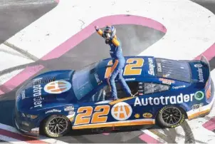  ?? AP PHOTO/HAKIM WRIGHT SR. ?? Joey Logano stands on his car Sunday after winning the NASCAR Cup Series auto race at Atlanta Motor Speedway in Hampton, Ga.