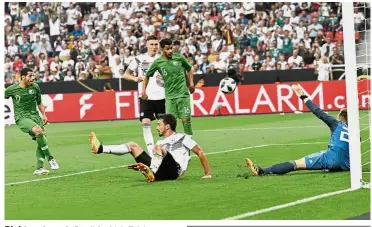  ??  ?? Right on target: Saudi Arabia’s Taisir Al-Jassim (left) scoring the first goal against Germany during an internatio­nal friendly at the BayArena in Leverkusen on Friday. — AP