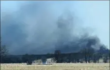  ?? PHOTO/KEVIN HARVISON/THE MCALESTER NEWS-CAPITAL ?? Smoke billows from the site of a gas well fire near Quinton, Okla., early Monday. Several people are missing after a fiery explosion ripped through the eastern Oklahoma drilling rig, sending plumes of black smoke into the air and leaving a derrick crumpled onto the ground, an emergency official said. AP