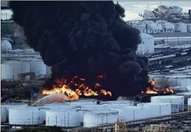  ?? DAVID J. PHILLIP / AP ?? Firefighte­rs battle a petrochemi­cal fire at the Interconti­nental Terminals Company Monday in Deer Park, Texas. The large fire at a Houston-area petrochemi­cals terminal will likely burn for another two days, authoritie­s said Monday, noting that air quality around the facility was testing within normal guidelines.