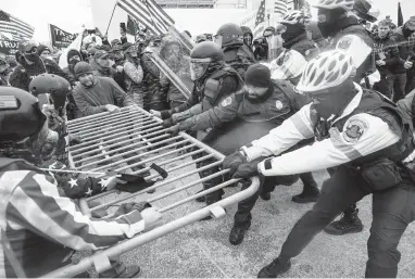  ?? JOHN MINCHILLO/ AP ?? Rioters square off against U.S. Capitol Police on Jan. 6 in Washington. Interviews with some members of the force revealed how unprepared they were to handle the mayhem that ensued after a speech by President Trump.