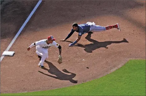  ?? Associated Press ?? Play at third: Seattle Mariners' Julio Rodriguez arrives safely to third base from first off a single by J.P. Crawford as San Diego Padres third baseman Manny Machado waits for the throw during the sixth inning of a baseball game Monday in San Diego.