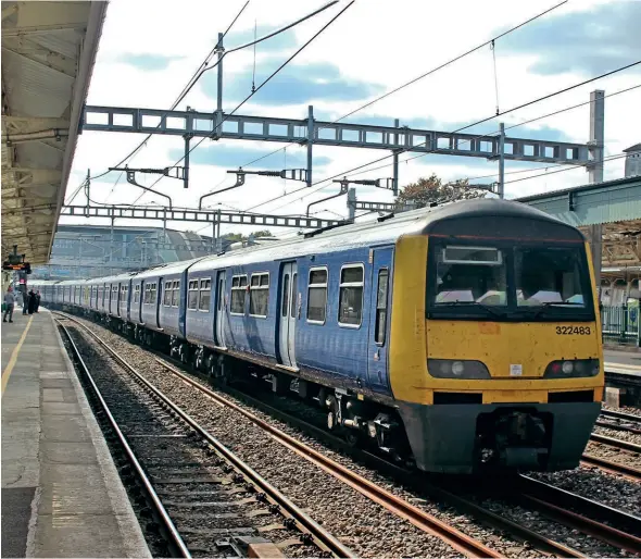  ?? ?? Final look at Class 322, as No. 322483 trails the move to Sims Metals, Newport through Newport station on September 21, with No. 37884 leading and No. 322485 behind. Martin Turner