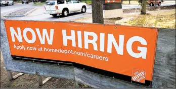  ?? STEVEN SENNE/AP ?? Vehicles drive past a help wanted sign Wednesday at a Home Depot store in Boston.