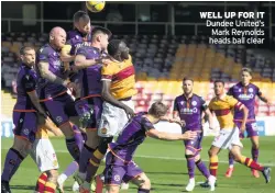 ??  ?? WELL UP FOR IT Dundee United’s Mark Reynolds heads ball clear