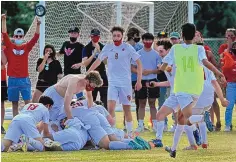  ?? JIM THOMPSON/JOURNAL ?? Members of the Albuquerqu­e Academy boys soccer team pile on Oliver Kumar to celebrate his goal early in overtime in their 4A title game against Los Alamos on Saturday.