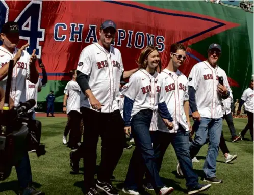  ?? STAN GROSSFELD/GLOBE STAFF ?? Brianna and Trevor Wakefield were escorted to the Fenway Park mound by the 2004 Red Sox world champions.