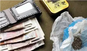  ??  ?? Ill-gotten gains: Police found drugs and a wallet stuffed with cash