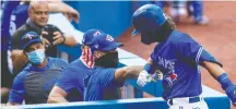  ?? CARLOS OSORIO / THE CANADIAN PRESS ?? High fives and handshakes don’t seem appropriat­e in a pandemic but elbow bumps are fine, and an elbow bump is exactly what Blue Jay Bo Bichette got from coach Pete Walker after hitting a home run in Thursday’s intrasquad game.