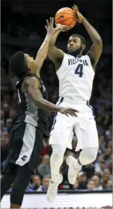 ?? LAURENCE KESTERSON — THE ASSOCIATED PRESS ?? Villanova forward Eric Paschall, right, takes a shot over Providence forward Rodney Bullock during the second half Wednesday night at Wells Fargo Center. Paschall and his fellow front-court members played strong games as the Wildcats stretched out to...
