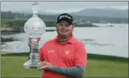  ?? ERIC RISBERG — THE ASSOCIATED PRESS ?? Ted Potter Jr. poses with his trophy on the 18th green of the Pebble Beach Golf Links after winning the AT&T Pebble Beach National Pro-Am golf tournament Sunday in Pebble Beach
