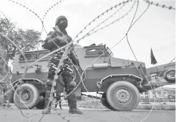  ?? — Reuters file photo ?? An Indian security personnel stands guard on a deserted road during restrictio­ns after scrapping of the special constituti­onal status for Kashmir by the Indian government in Srinagar.