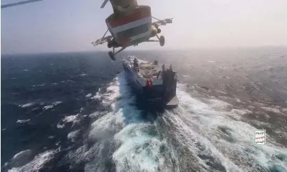  ?? ?? A Houthi helicopter flies over a cargo ship in the Red Sea. Photograph: Houthi Military Media/Reuters