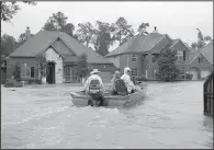  ?? AP/DAVID J. PHILLIP ?? Volunteer rescue boaters enter a flooded subdivisio­n Monday in Houston. As federal disaster officials prioritize funding to focus on immediate needs, money for recovery and rebuilding will flow more slowly.