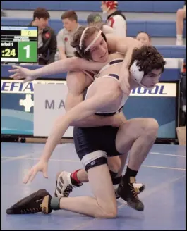  ?? ?? Photo credit: Tom Hendrixson
Wapak’s Corbin Mitchell battles a Napoleon opponent in last week’s sectional wrestling tournament. He and his Redskin team mates are working to advance to the state tournament at the Norwalk District on Saturday.