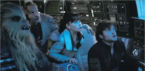  ?? DISNEY ?? Joonas Suotamo, left, as Chewbacca, Woody Harrelson as Tobias Beckett, Emilia Clarke as Qi’ra and Alden Ehrenreich as Han Solo star in the second stand alone Star Wars movie Solo: A Star Wars Story.