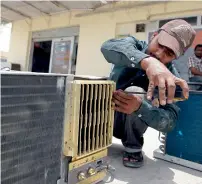  ?? KT file photo ?? Technician­s are busy with calls seeking repair and servicing of all kinds of ACs — split, window and central. —
