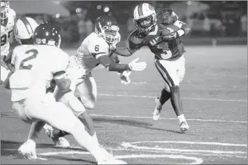  ?? PHOTOS BY KYLE KURLICK/SPECIAL TO THE COMMERCIAL APPEAL ?? Briarcrest’s Rashad Muhammad runs the ball downfield while ECS’s Esai Diaz attempts to tackle him. The Eagles won 33-32 in overtime as Cole Heotis scored three touchdowns.