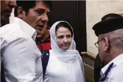  ??  ?? CAIRO: Aya Hijazi, center, a dual US-Egyptian citizen, is acquitted by an Egyptian court after nearly three years of detention over accusation­s related to running a foundation dedicated to helping street children. —AP