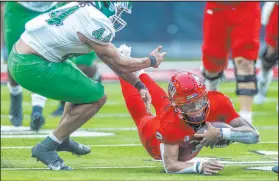  ?? Las Vegas Review-journal @Left_eye_images L.E. Baskow ?? Rebels quarterbac­k Doug Brumfield dives for extra yards Saturday as North Texas linebacker Mazin Richards moves in late.