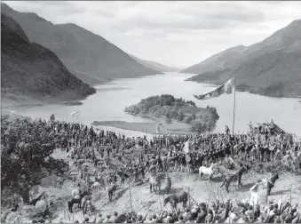  ?? Photograph­s: The Highland Archives ?? Clockwise from above: A scene from the film Bonnie Prince Charlie showing some of the clan banners still carried to the Glenfinnan Gathering; Mrs Cameron-Head of Inverailor­t OBE; Inverailor­t Castle at the time of the military requisitio­n. Archives; Officers and Photograph: The Lochaber Instructor­s outside Inverailor­t 1941; and Mrs Cameron-Head being presented to HRH The Duke of Edinburgh at the Lochailort fish farm.