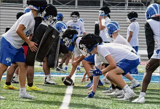  ?? Will Waldron / Times Union ?? Shaker football players run drills during their first practice of the season on Monday. Shaker lost to Guilderlan­d in last season’s Class AA title game.