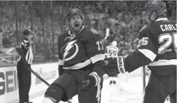  ?? KIM KLEMENT/USA TODAY SPORTS ?? Tampa Bay center Alex Killorn, left, celebrates after scoring the game-winning goal in the third period of Game 5.