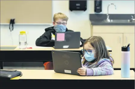  ?? TED S. WARREN — THE ASSOCIATED PRESS FILE ?? Students wear masks as they work in a fourth-grade classroom, at Elk Ridge Elementary School in Buckley, Feb. 2, Wash. Amid mounting tensions about school reopening, the Centers for Disease Control and Prevention planned to release long-awaited guidance Feb. 12 on what measures are needed to get children back into the classroom during the pandemic.