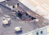  ?? SOURCE: KMOV ?? The roof of a box company in St. Louis is blown open after a boiler exploded in that business and hit another business nearby.