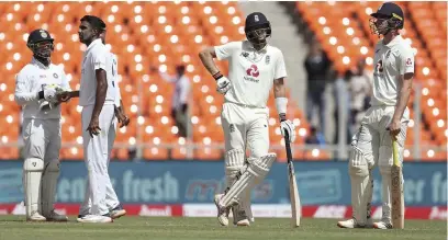  ??  ?? ■ Joe Root, second right, awaits third umpire’s decision before he is given out on a delivery by Ravichandr­an Ashwin.